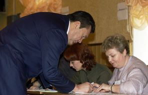 На фото: кандидат в президенты - премьер-министр Украины Виктор Янукович (слева) проголосовал на избирательном участке N10 территориального избирательного округа N219, 2004