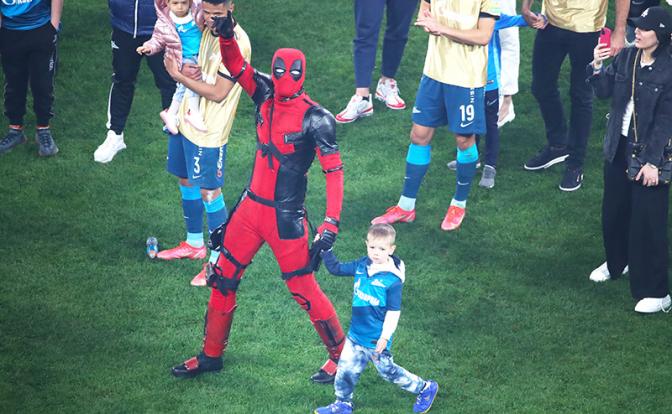 На фото: игрок "Зенита" Артем Дзюба в костюме Дэдпула с сыном Максимом (в центре) на церемонии награждения после матча чемпионата России по футболу против команды "Локомотив".