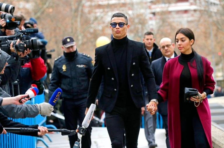 На фото: нападающий ФК "Ювентус" Криштиану Роналду с подругой Жоржиной Родригес у здания суда перед заседанием по делу о четырех налоговых преступлениях, совершённых им в период с 2011 по 2014 год. Роналду признал вину и заплатит штраф в размере € 18,8 млн., 2019 год.